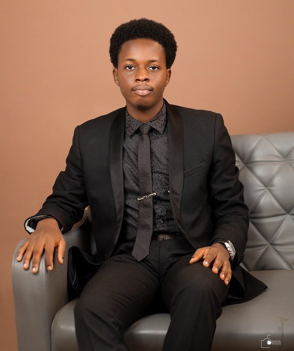 Portrait in a black suit, seated in an armchair
