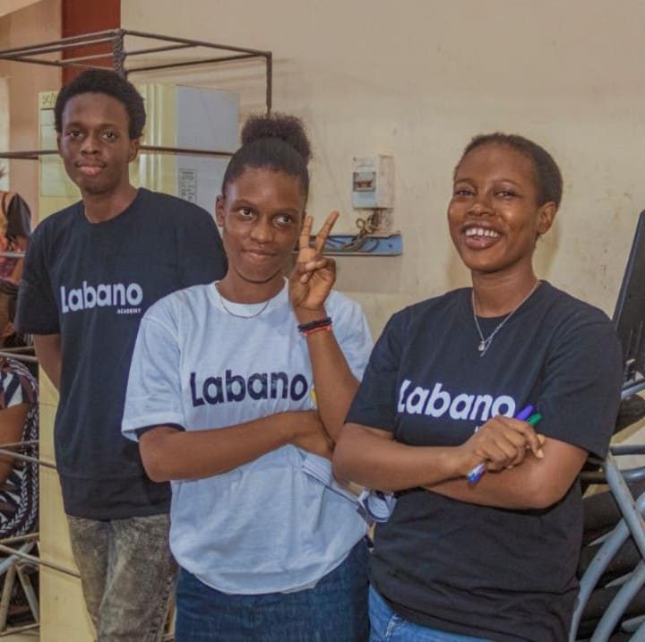 Three people in Labano t-shirts in a classroom