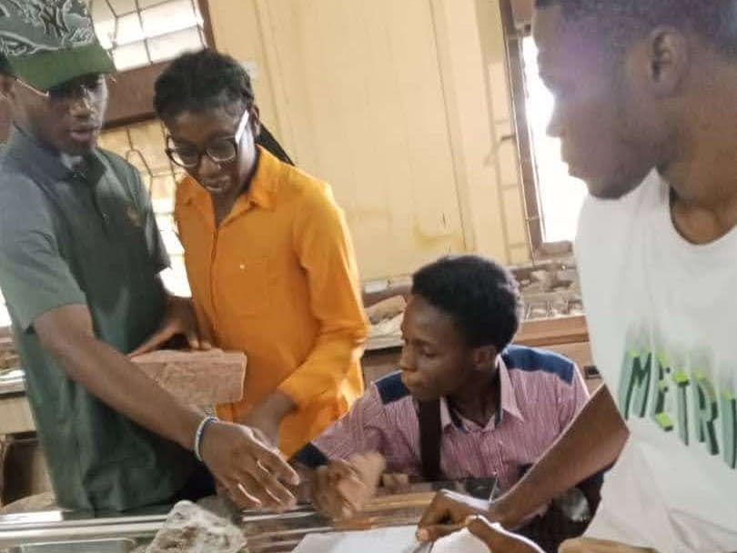 Students working with sediment samples at a lab bench